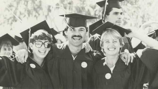 Graduates in 1985 smiling for the camera.