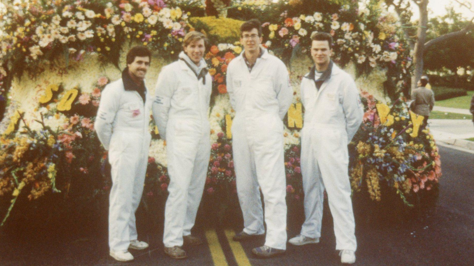 Group of Cal Poly alumni standing in front of a float at the Rose Parade.