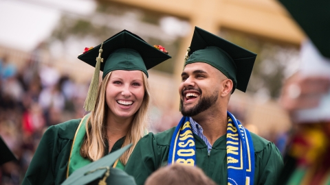Two grads at the 2018 spring commencement ceremony. 