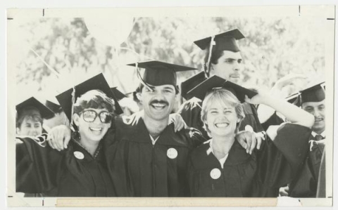 Three graduates celebrating in 1985