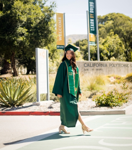 Cal Poly grad on campus wearing cap and gown
