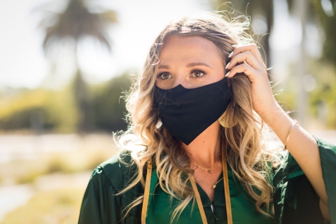 Cal Poly grad wearing mask cap gown in quarantine