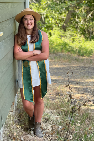 Alumna Rachel Baer posing for her graduation photo.