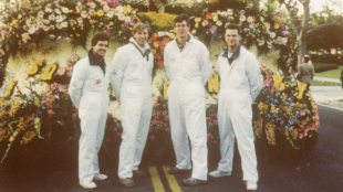 Group of Cal Poly alumni standing in front of a float at the Rose Parade.