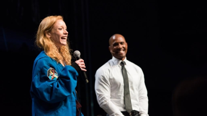 Lacey Davis speaks as Victor Glover looks on