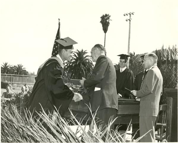 Frank Ross steps up to the dais as one of the four candidates who obtained their master's degrees at the June 1951 graduation exercises