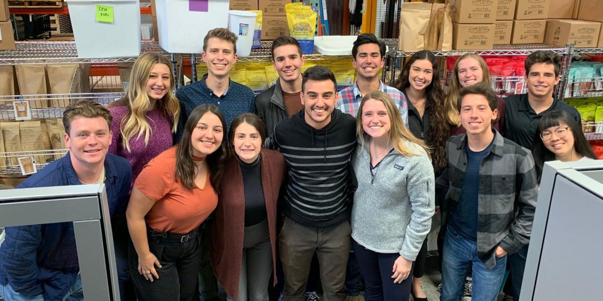 A group of Cal Poly Students poses in the granola factory