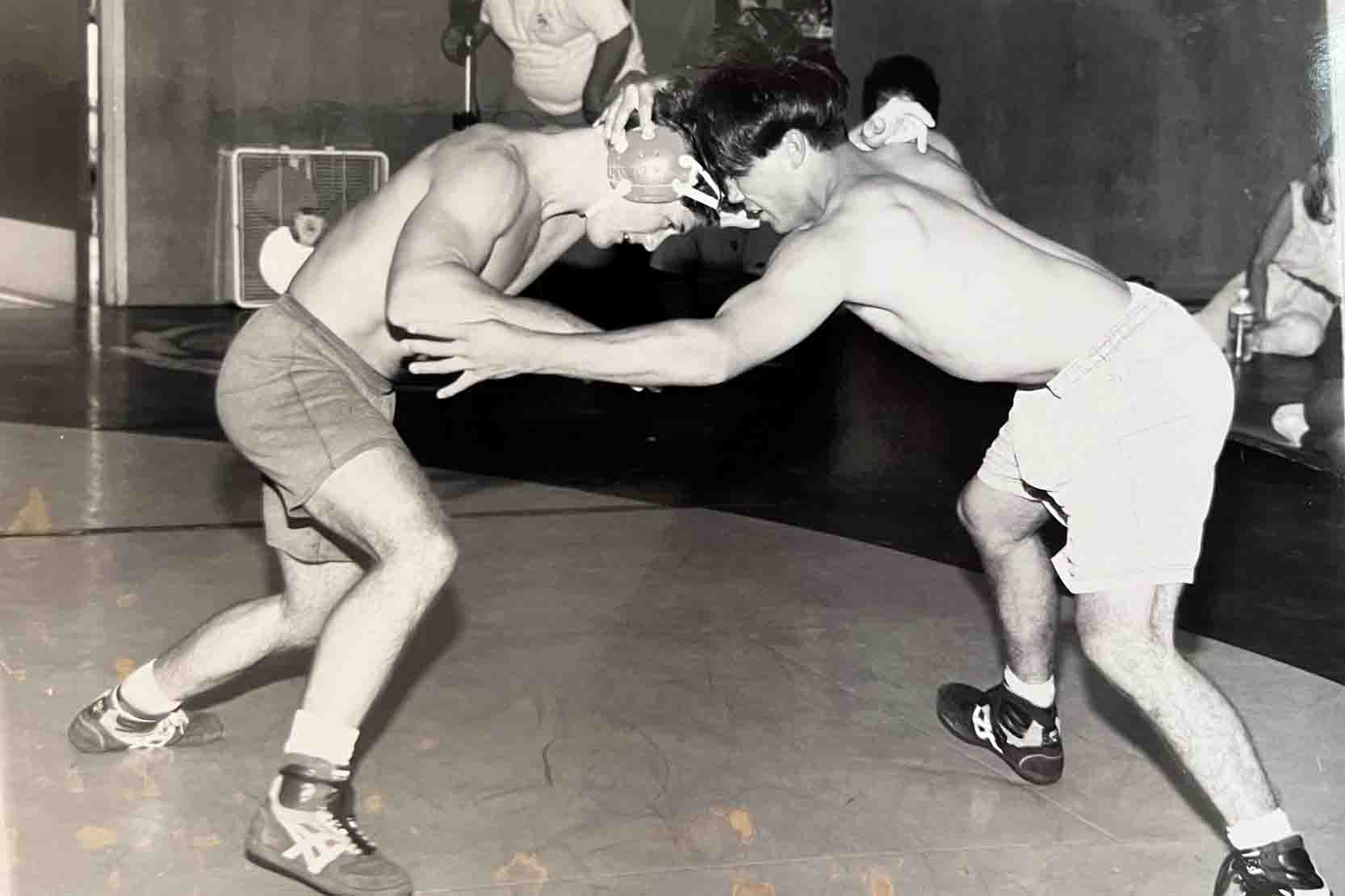 Jason Wheeler (left) wrestling at Cal Poly.