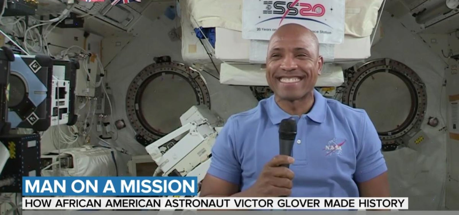 A photo of Astronaut Victor Glover smiling into the camera aboard the International Space Station