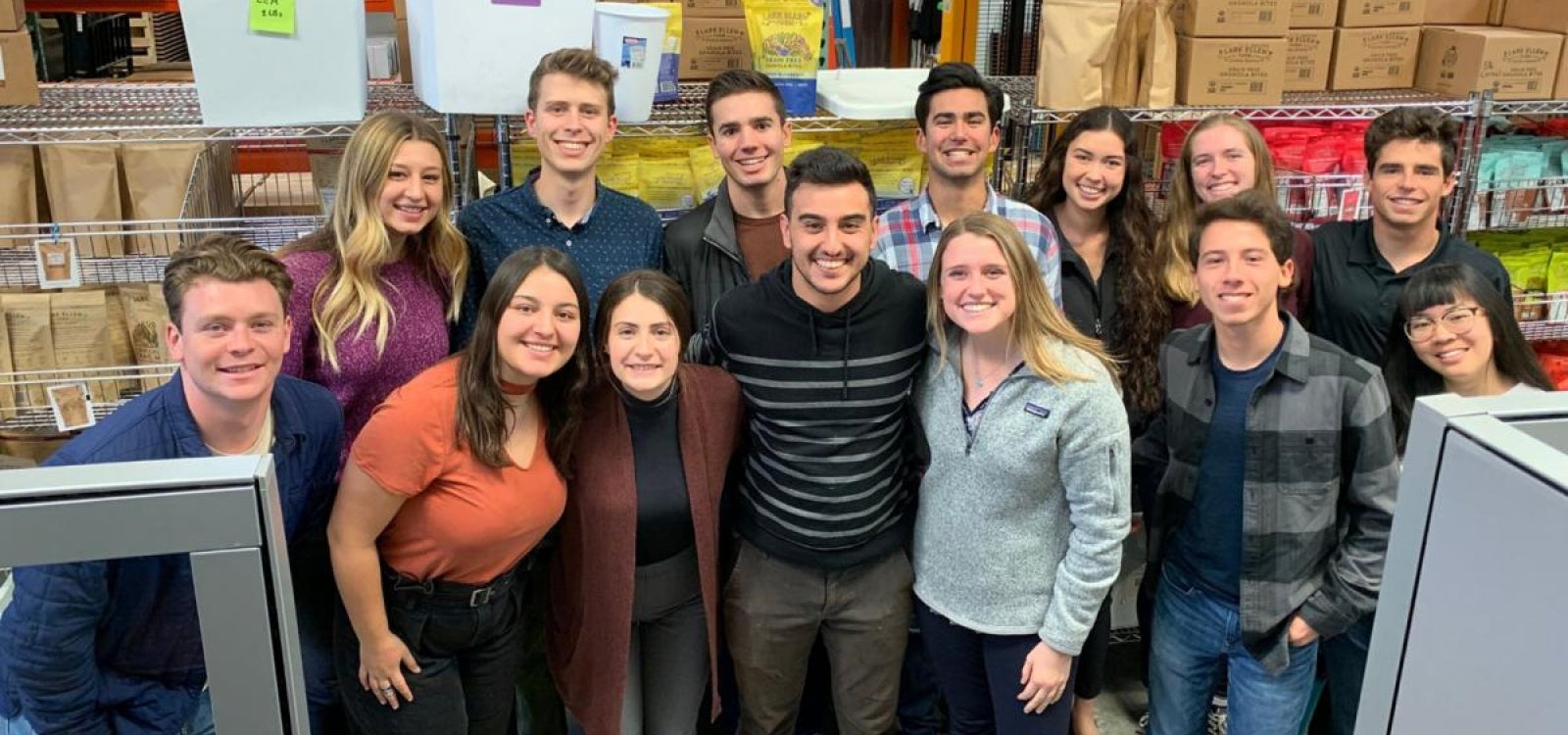A group of Cal Poly Students poses in the granola factory 