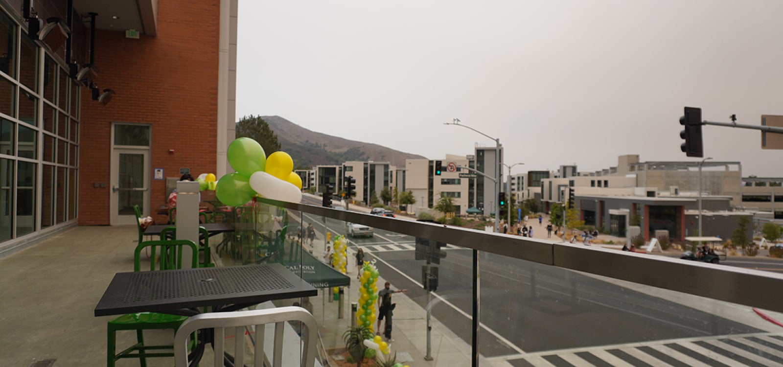 Outdoor seating on the second floor with a view over Grand Avenue