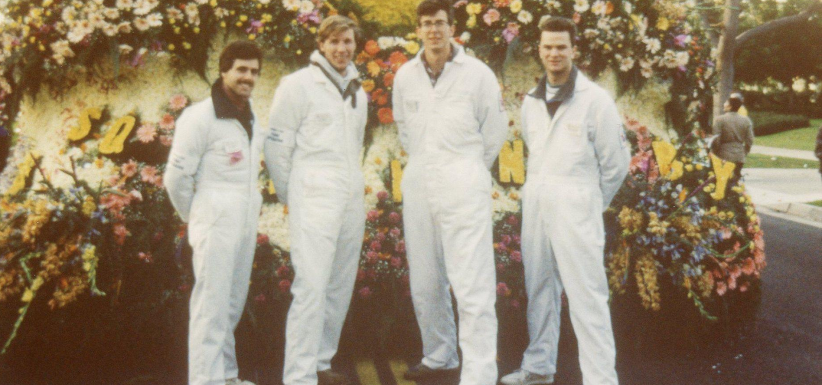 Group of Cal Poly alumni standing in front of a float at the Rose Parade.