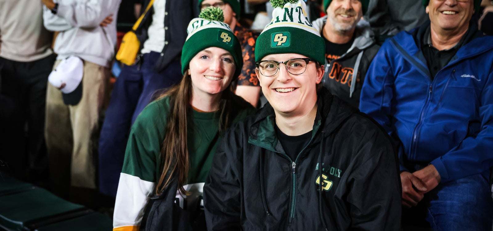 Alumni wearing the Cal Poly x Giants beanies.