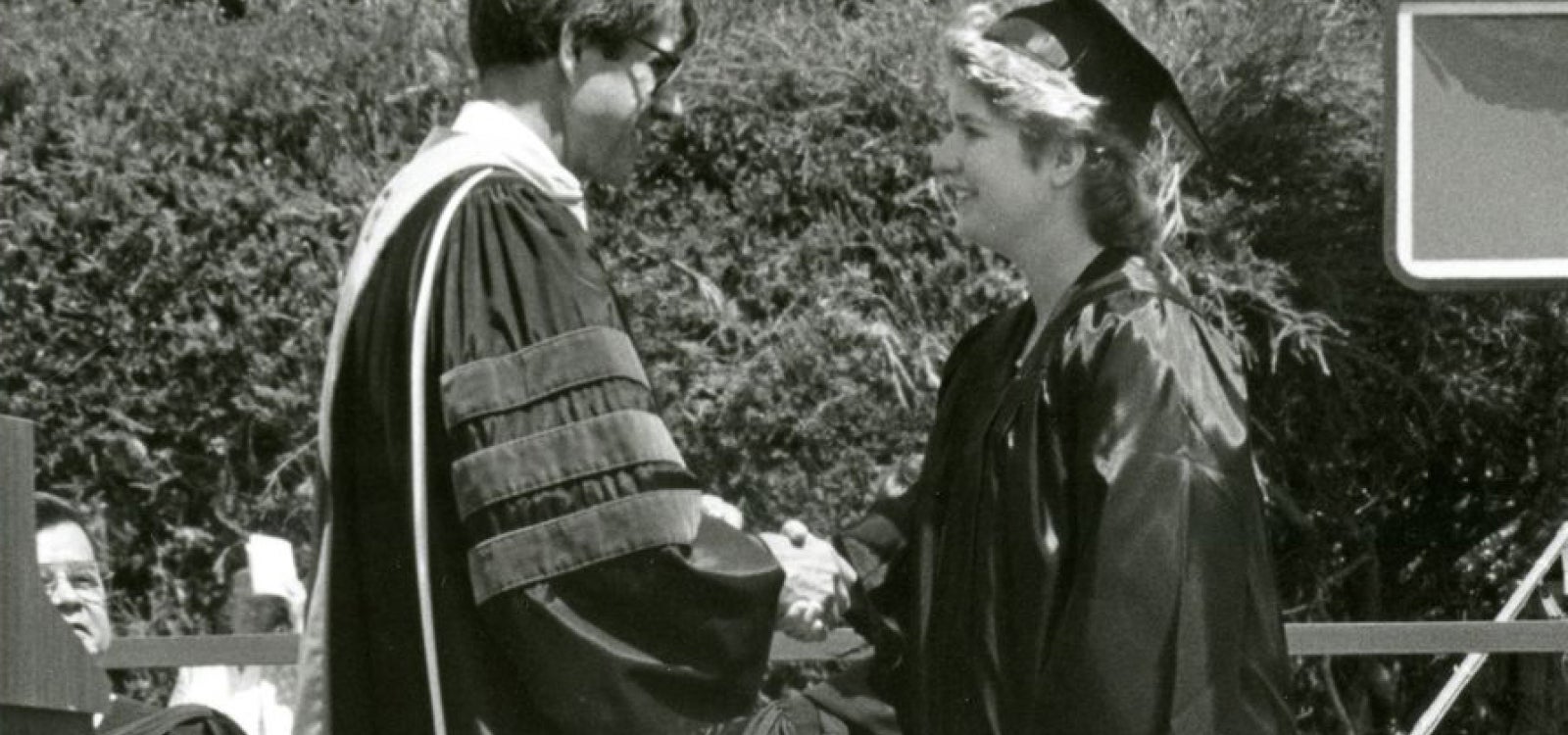 Commencement 1988. President Warren J. Baker and graduate Priscilla Butler shake hands as she is recognized for her academic excellence in Liberal Arts. She was also Cal Poly's youngest graduate at the age of 18.