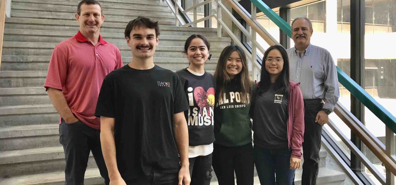 Alumnus Jason Wheeler with students and a professor