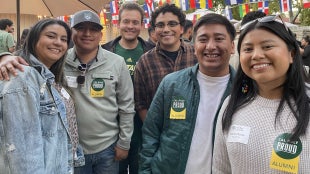 Alumni smiling for the camera