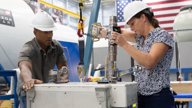 NASA Commercial Crew Program astronauts Nicole Mann and Victor Glover learn about the tools and hardware they will use in spacewalk training at NASA’s Space Vehicle Mockup Facility in Houston.