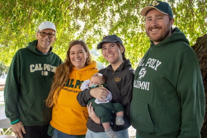 Alumni family smiling for the camera. 