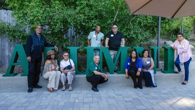 Alumni smiling for the camera.