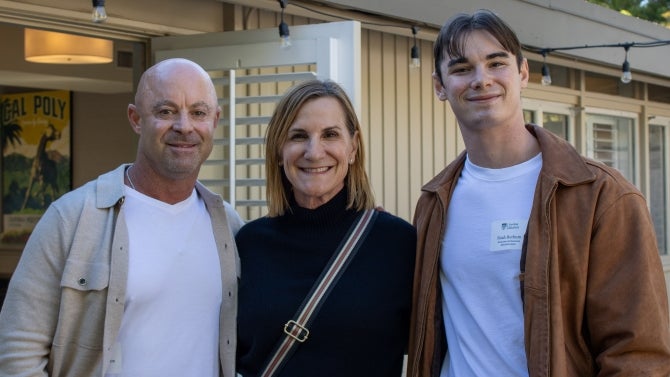 Alumni family smiling for the camera. 