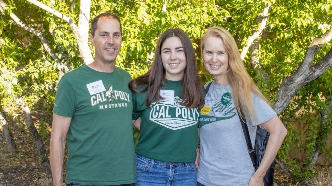 Alumni family smiling for the camera. 