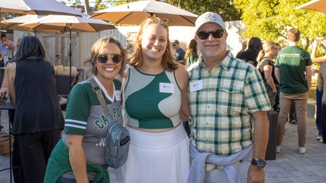 Alumni family smiling for the camera. 