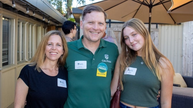 Alumni family smiling for the camera. 