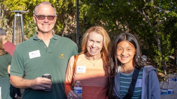 Alumni family smiling for the camera. 