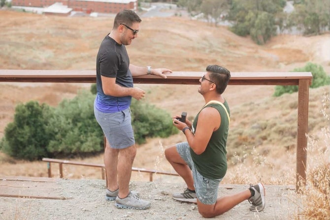 Two alumni getting engaged while hiking the Cal Poly P