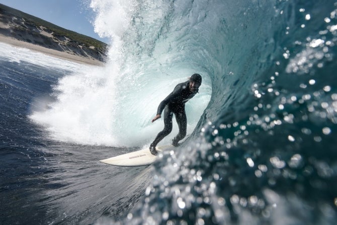 Alumnus surfing a wave