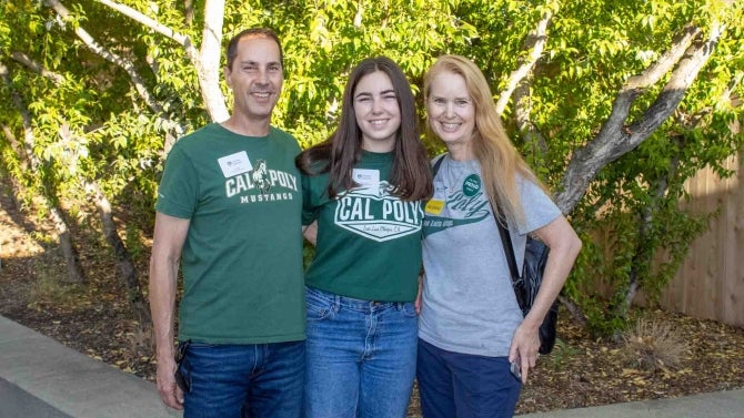 Alumni family smiling for the camera. 