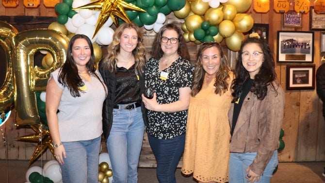 Alumni smiling for the camera.