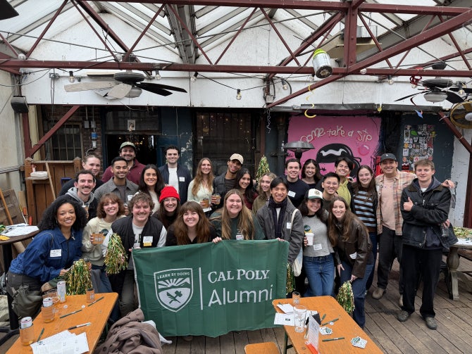 A group with a flag smiles for the camera