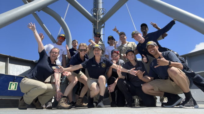 Two rows of people pose for a photo