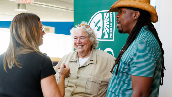 Three people face each other and chat at Cal Poly Maritime Welcome