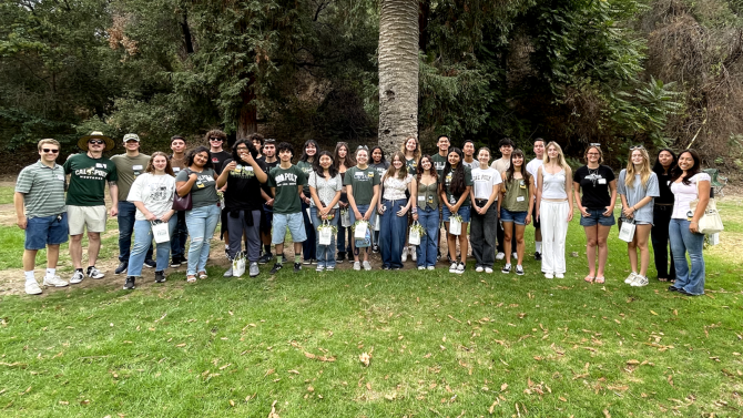 A group of people stand and smile for the photo