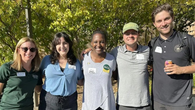 A group of Cal Poly alumni smile for the camera. 