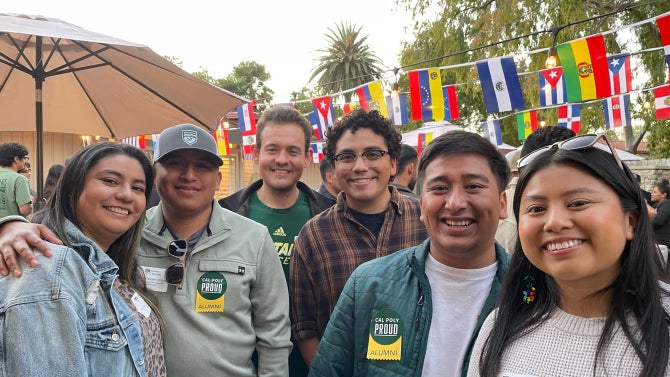 Cal Poly Alumni smiling for a group photo. 